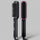 Black hair straightening brush with pink accents on a dark purple background