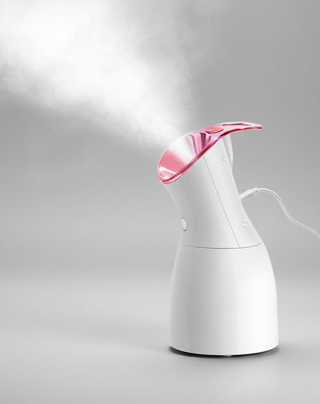White handheld steamer with pink top emitting steam on a dark background