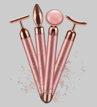 Set of rose gold facial massagers on a pink background