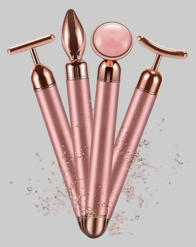 Set of rose gold facial massagers on a pink background
