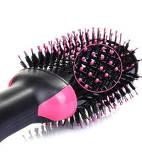 Hairbrush with black bristles and pink accents on a white background