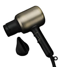 Black and gold hair dryer on a dark marble surface