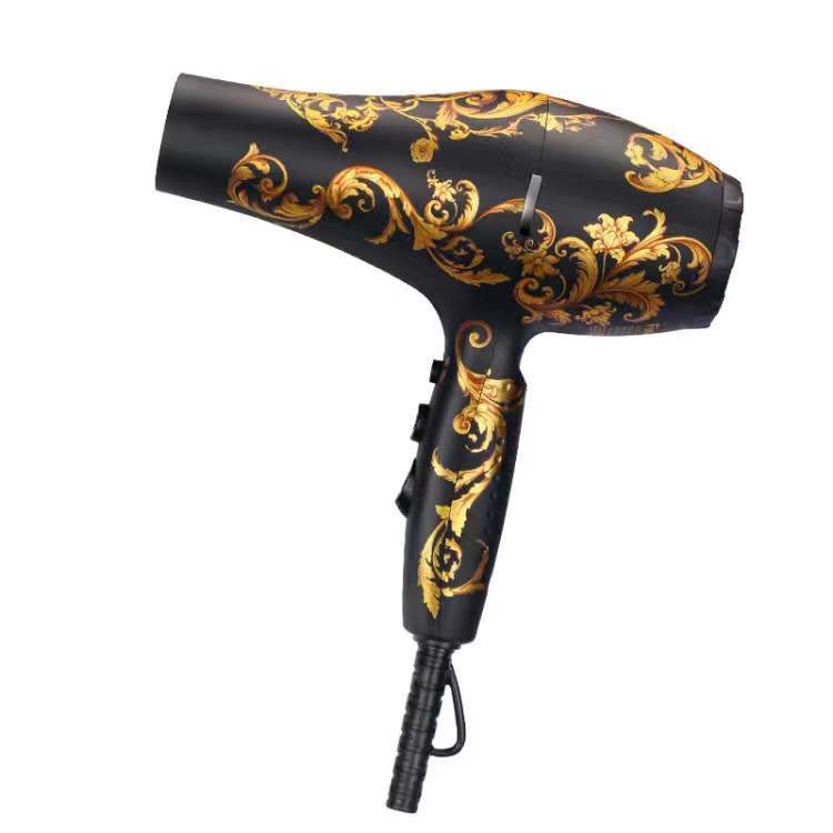 Black hair dryer with gold decorative patterns on a white background