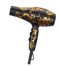 Black hair dryer with gold decorative patterns on a white background