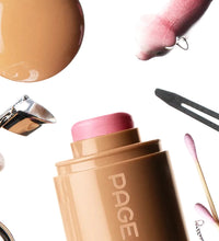 Cosmetic stick with pink cap and 'PAGE' branding, surrounded by makeup tools on a white background.