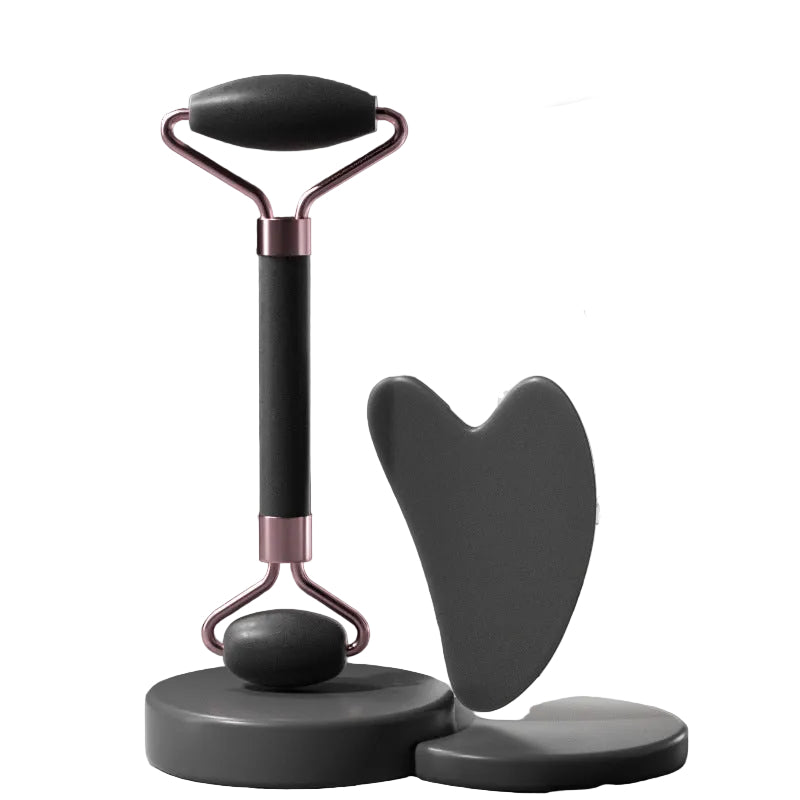 Facial roller and gua sha tool with packaging on a dark background