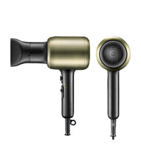 Gold and black hair dryer with nozzle attachment on a dark background