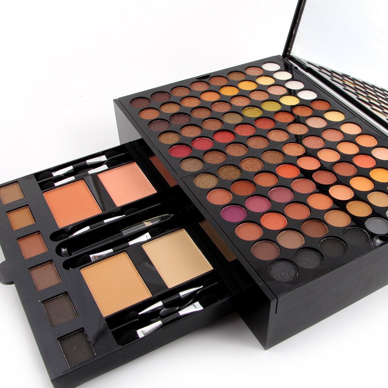 Makeup palette with various shades and brushes on a white background