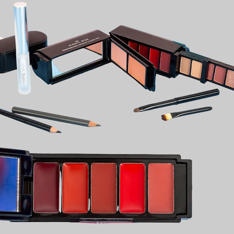 Makeup palettes with lipsticks and brushes on a blue surface