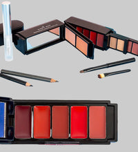 Makeup palettes with lipsticks and brushes on a blue surface