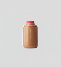 Makeup stick with pink cap and visible brand name on a white background