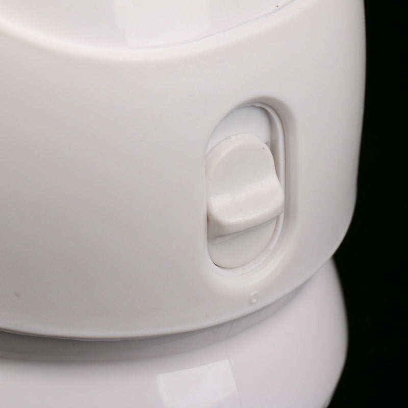 Close-up of a white ceramic teapot with a handle on a black background