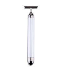 White handheld device with a metallic top on a white background