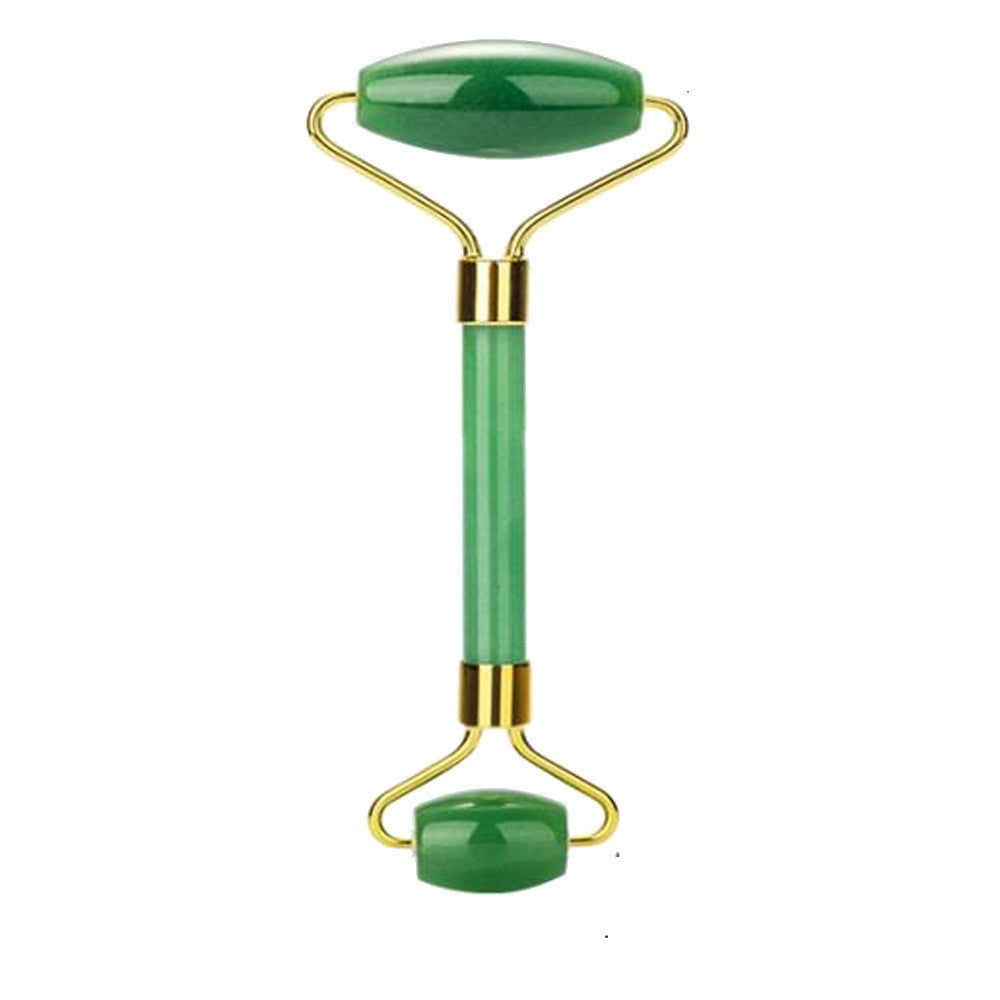 Jade facial roller with gold accents on a white background