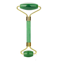 Jade facial roller with gold accents on a white background