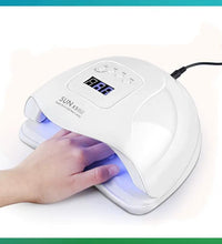 SUNX5PLUS nail lamp with a hand under it on a white background
