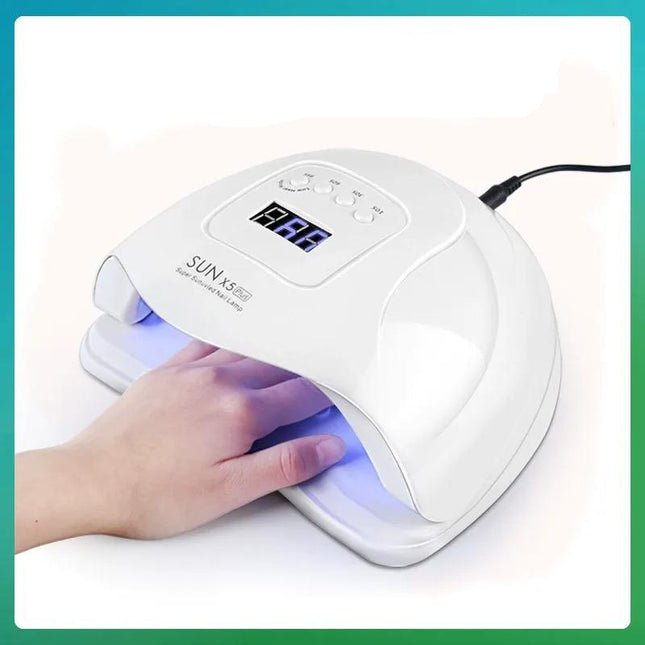 SUNX5PLUS nail lamp with a hand under it on a white background