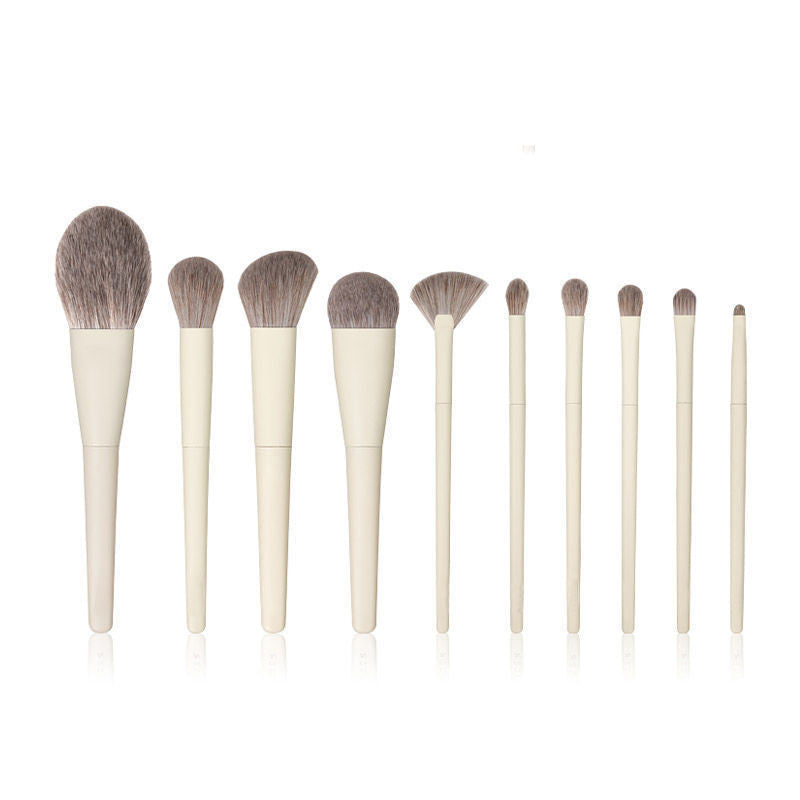 Set of makeup brushes with wooden handles and natural hair bristles on a white background.