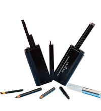 Set of makeup products including lip pencils and applicators on a blue surface with a pink background.