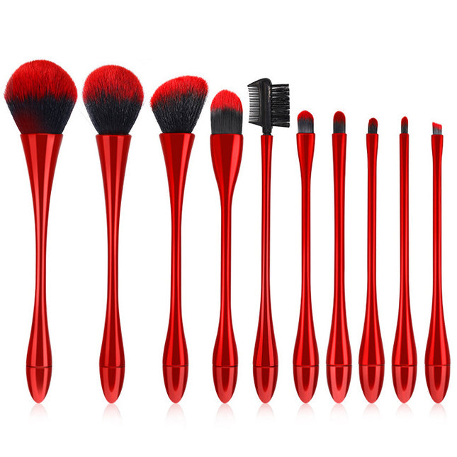 Set of red makeup brushes with black bristles on a white background