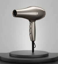 Silver hair dryer on a dark gray background