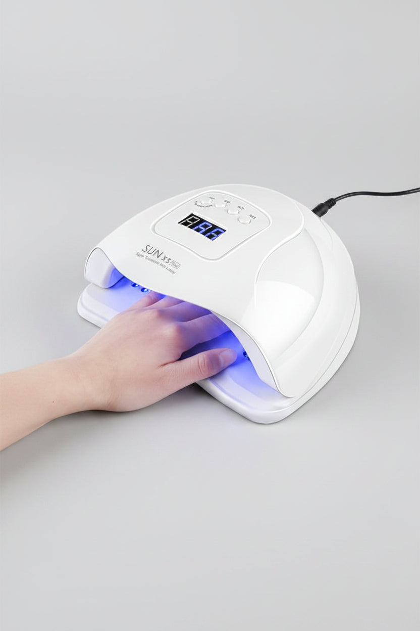 Smart nail therapy lamp with a hand under it on a white background