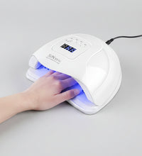 Smart nail therapy lamp with a hand under it on a white background