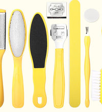 Set of yellow foot care tools including a file, scrubber, and other items on a white background.