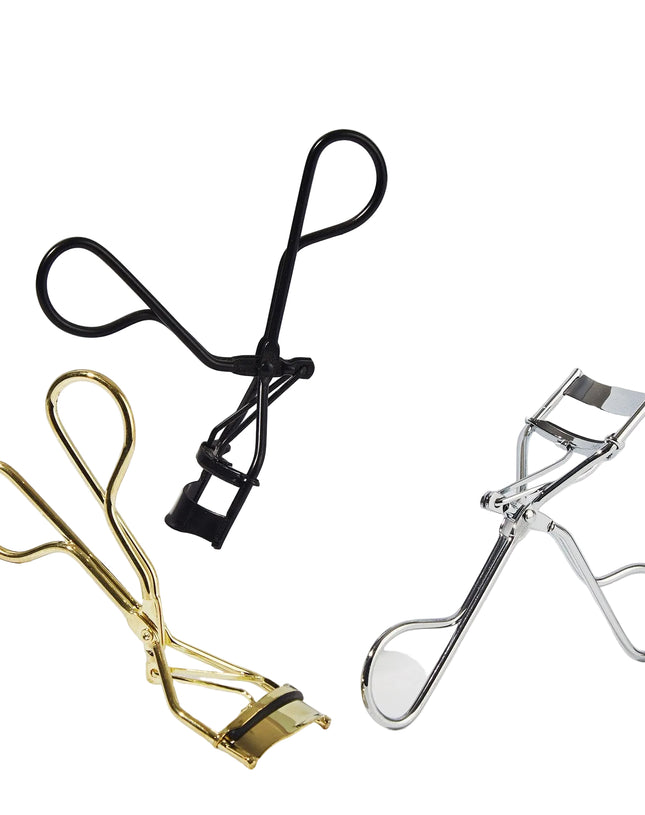 Three eyelash curlers in black, gold, and silver on a white background