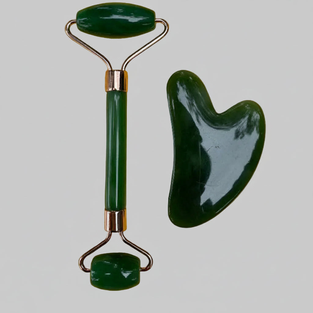 Green jade roller and scraping board on a yellow background
