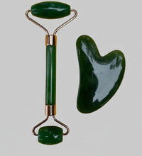 Green jade roller and scraping board on a yellow background