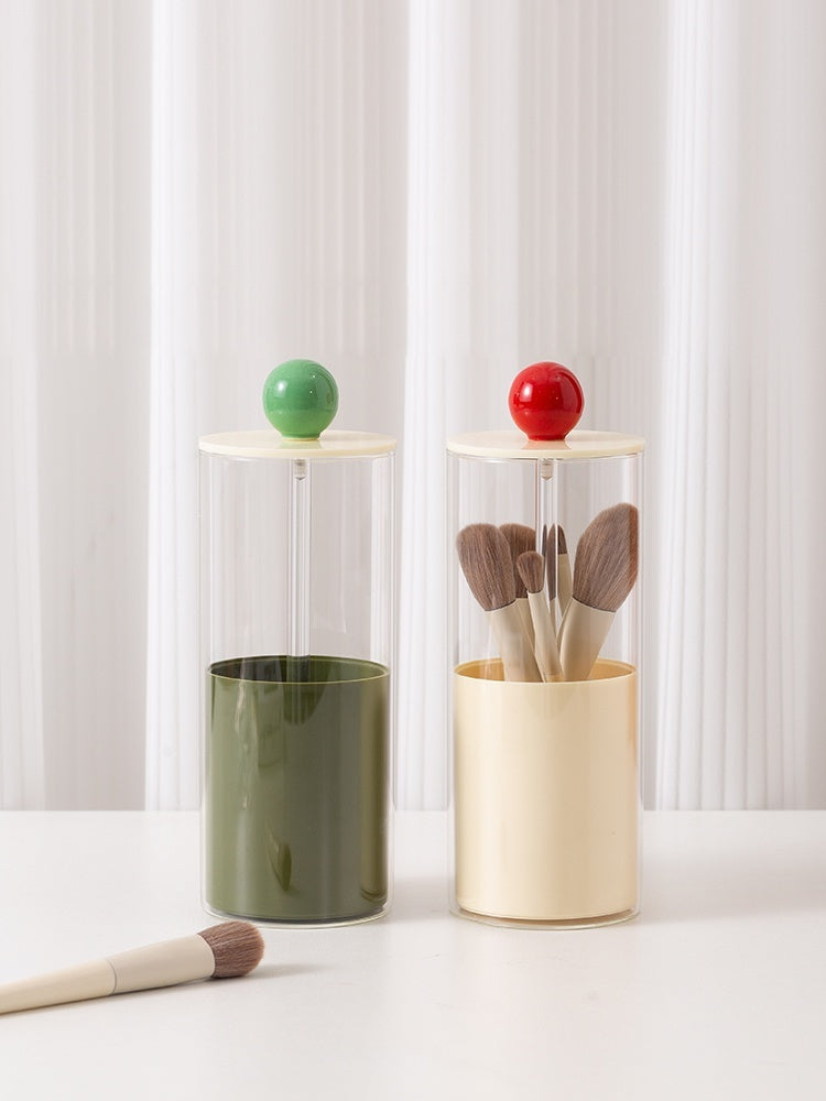 Two cylindrical containers with colorful tops on a white surface.