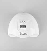 White nail lamp with digital display and Australian plug adapter on a white background