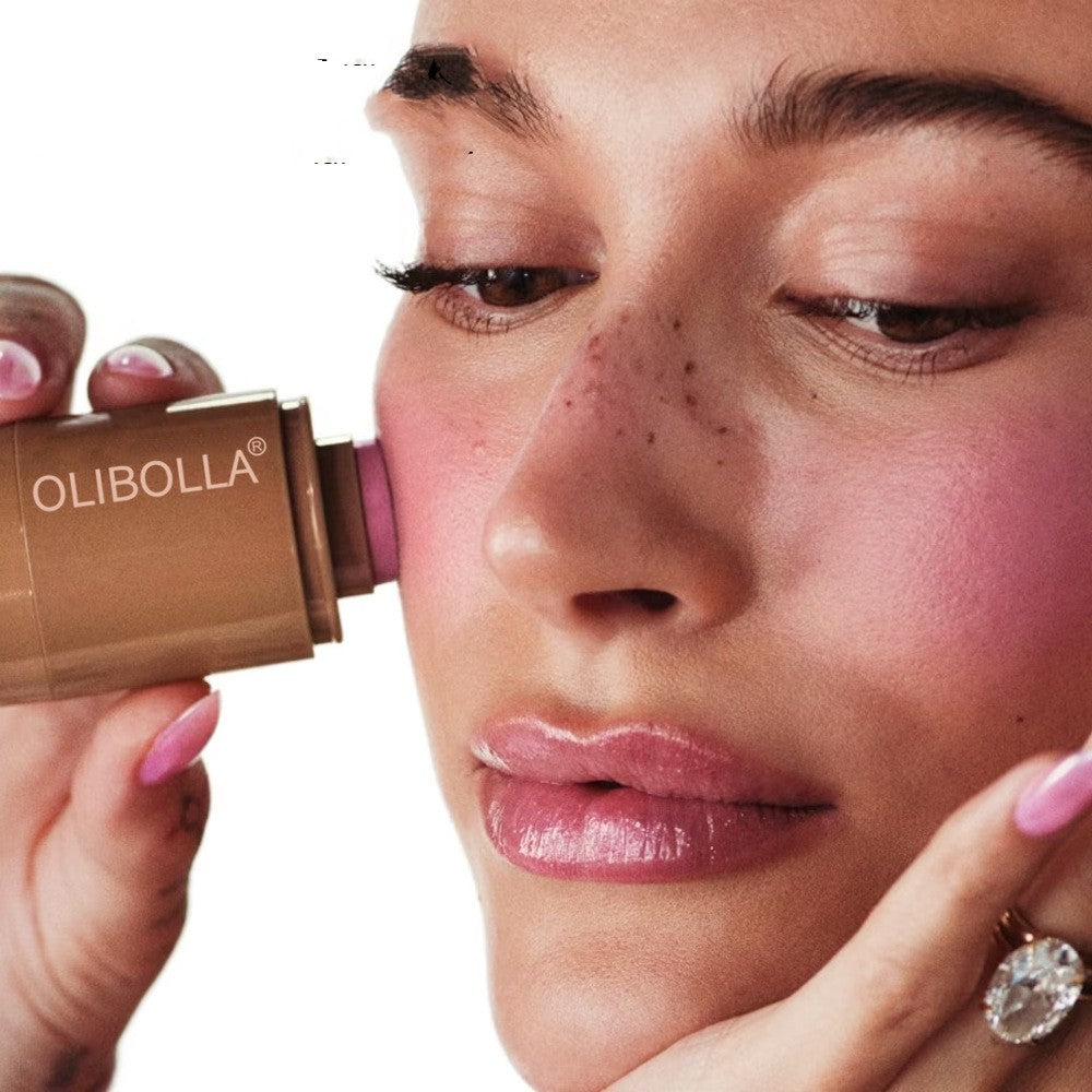 Woman applying Olibolla lipstick to her lips with a close-up view.