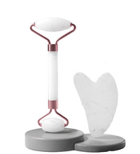 Professional grade facial massager set including a roller and scraping board.