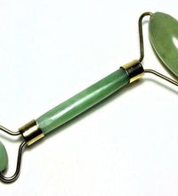 Green jade facial roller on a white background