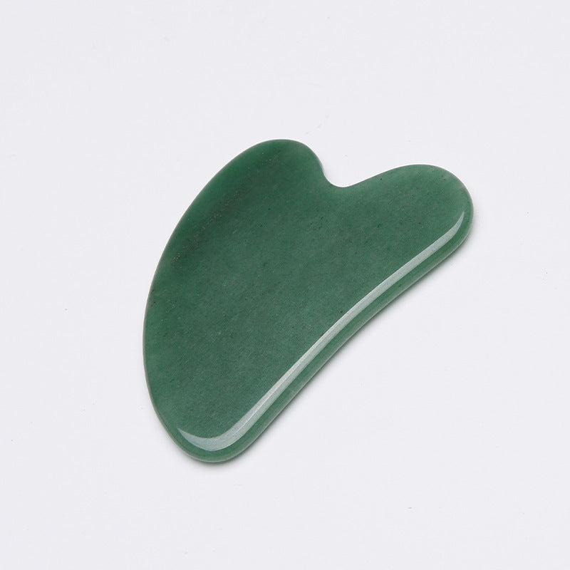 Green stone tool on a light gray background