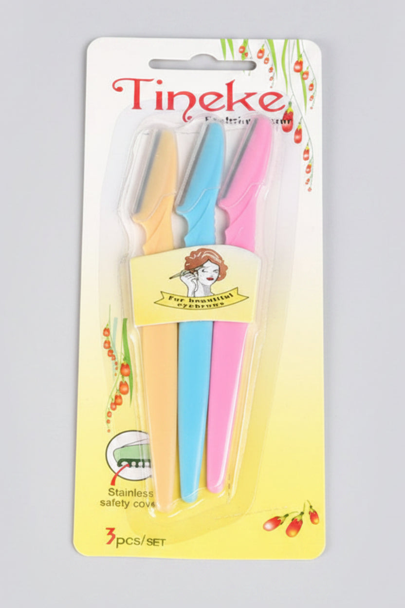 Packaged toothbrushes with colorful handles and 'Tineke' branding on a light blue background.