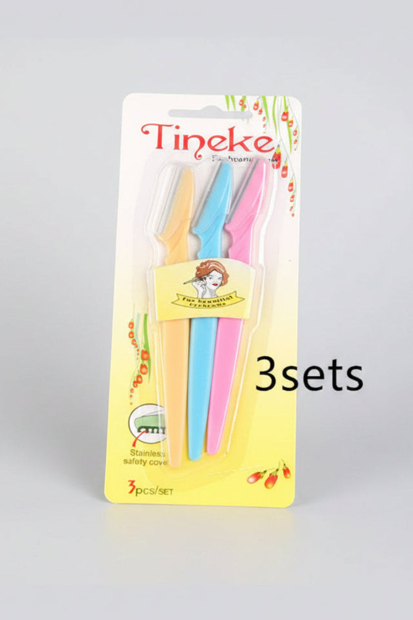 Packaged toothbrushes with colorful handles and 'Tineke' branding on a light blue background.