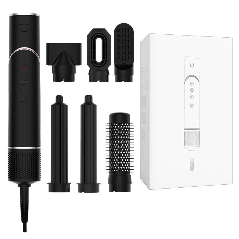 Black hair styling tool with attachments and packaging on a white background