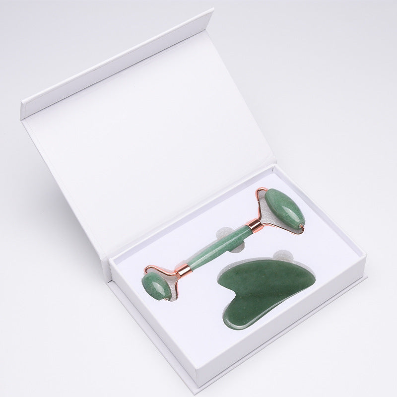 Jade facial roller and gua sha tool set in a white box on a light gray background
