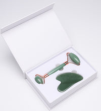 Jade facial roller and gua sha tool set in a white box on a light gray background
