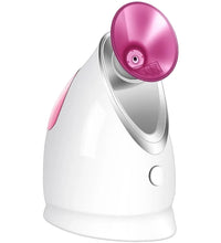 White and pink facial steamer on a white background