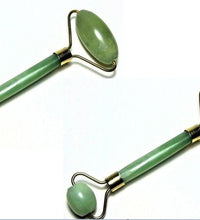 Two green jade rollers on a white background