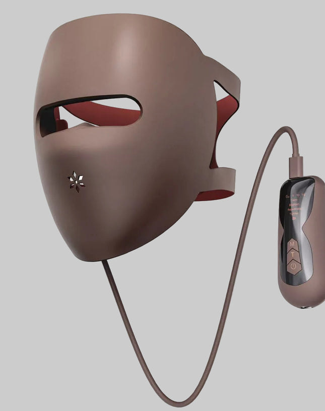 Brown LED face mask with remote control on a white background