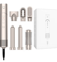 Hair styling tool with multiple attachments and packaging on a white background