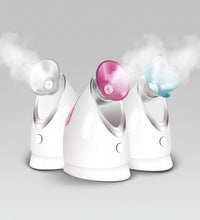 Three facial steamer devices with color-changing nozzles on a pink background.