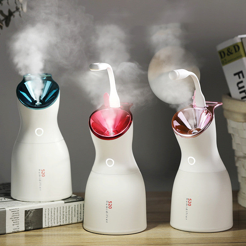 Three small humidifiers emitting steam on a wooden surface with a blurred background.