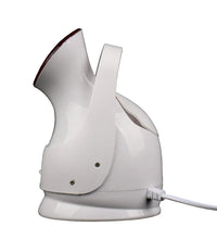White handheld steamer on a black background