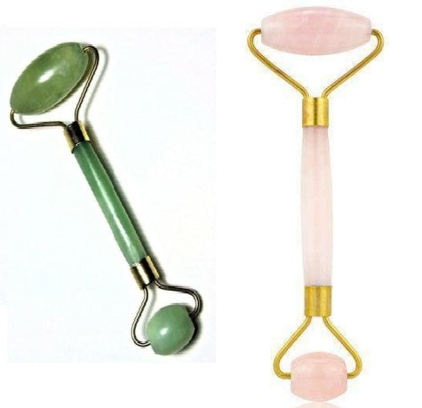 Two facial rollers, one green and one pink with gold accents, on a white background.